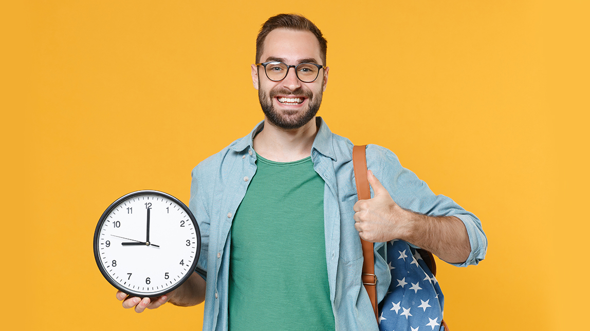 Smiling young man student in casual clothes glasses with backpack