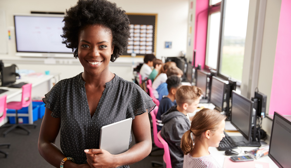 Portrait Of Female Teacher Holding IBDP teaching files in high school.